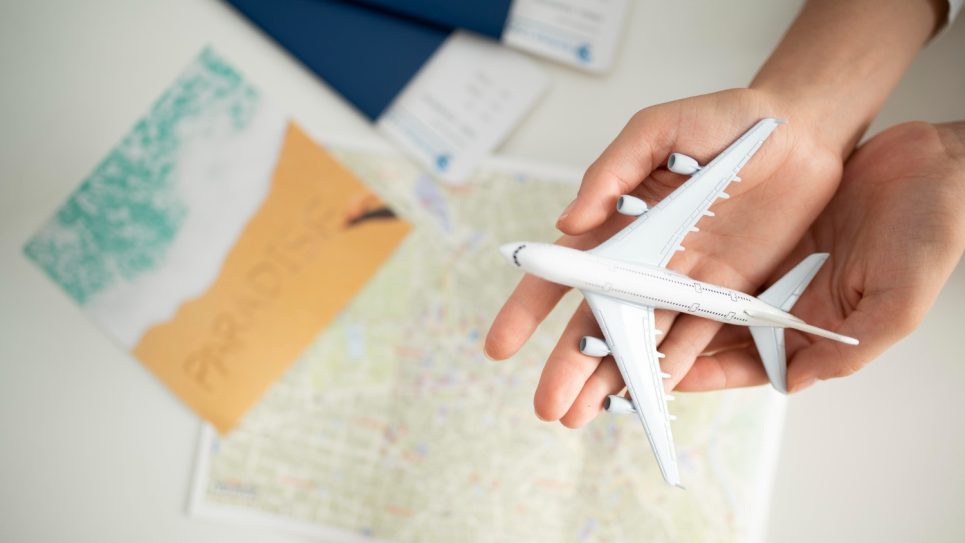 close-up-hands-holding-small-plane-top-view